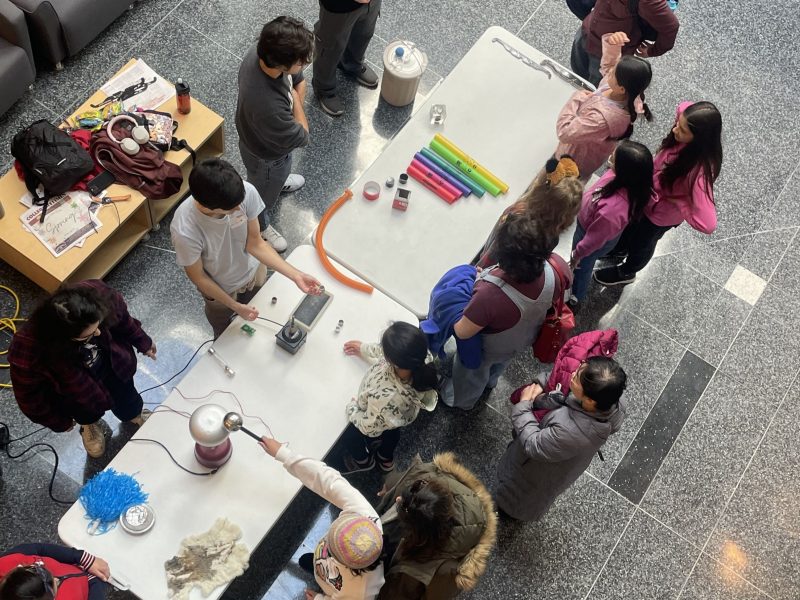 A group of students around an interactive STEM activity at Kids' Tech University.